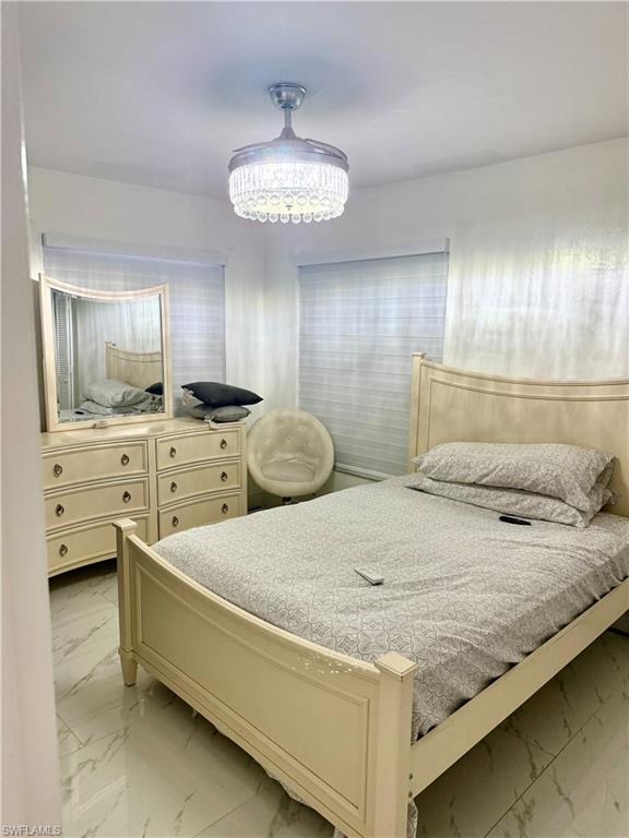 Bedroom with light marble finish flooring