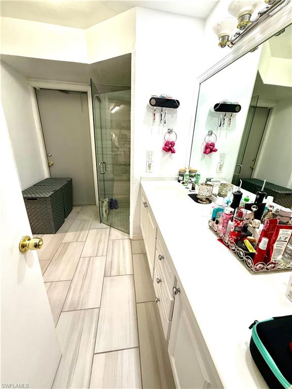 Full bath with a stall shower and double vanity