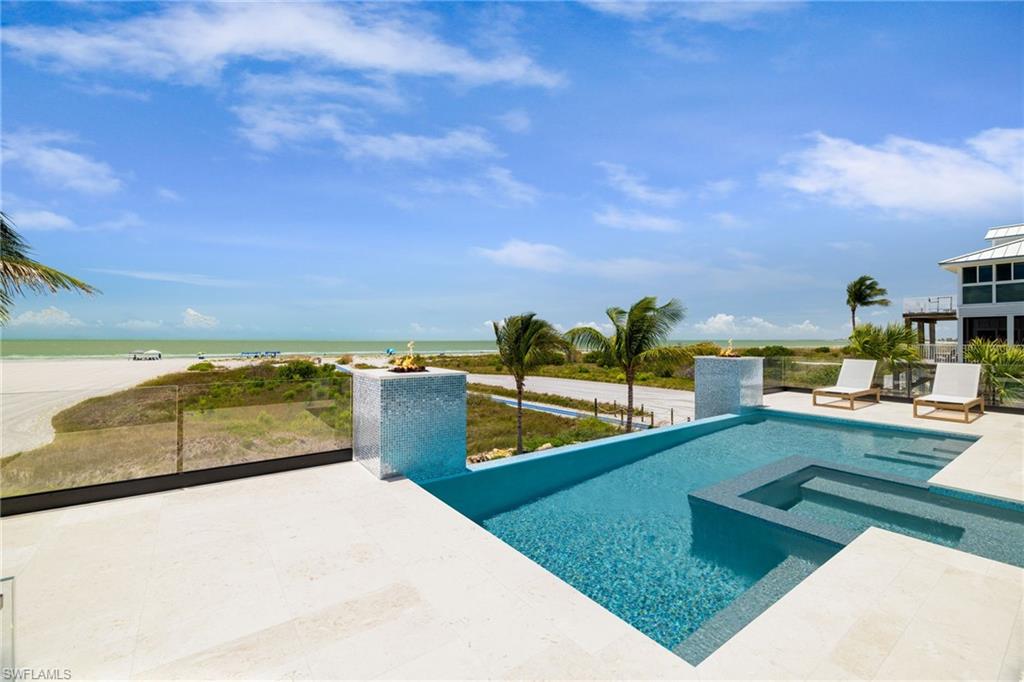 Infinity-edge swimming pool with an integrated spa and surrounding sun deck