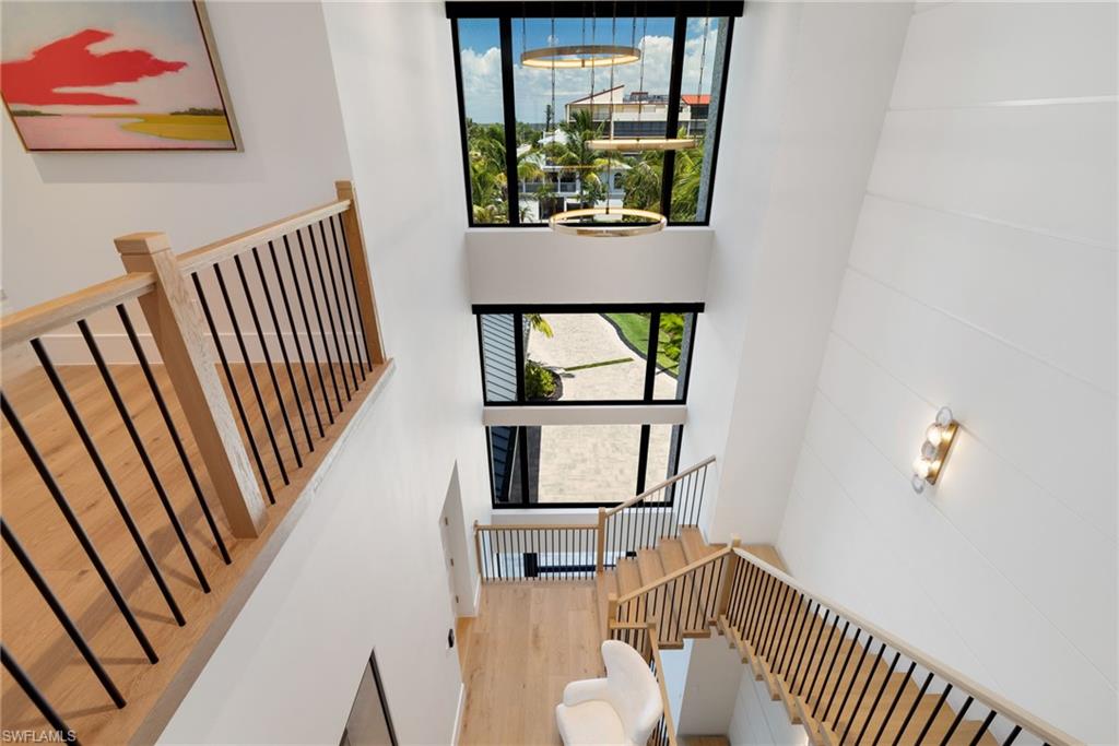 triple-height foyer featuring multiple large windows and chandelier