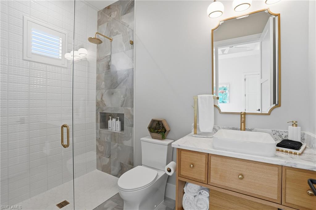 Full bathroom featuring vanity and a stall shower - Virtually Edited Image