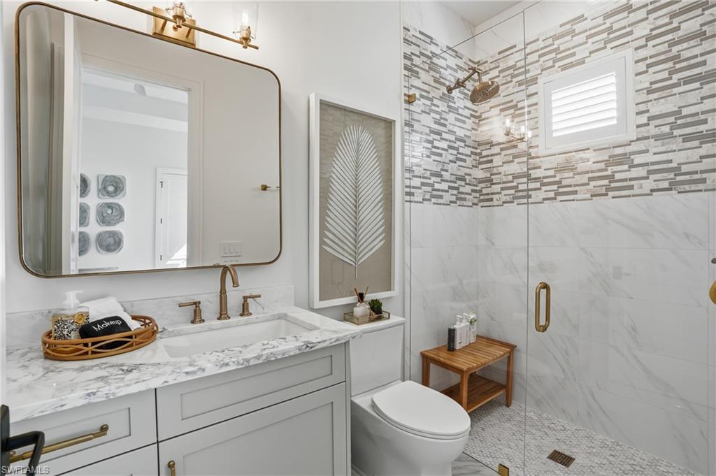 Full bathroom featuring vanity and a stall shower  - Virtually Edited Image