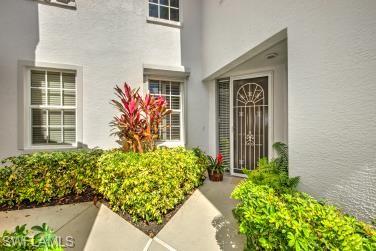 Entrance to property with stucco siding