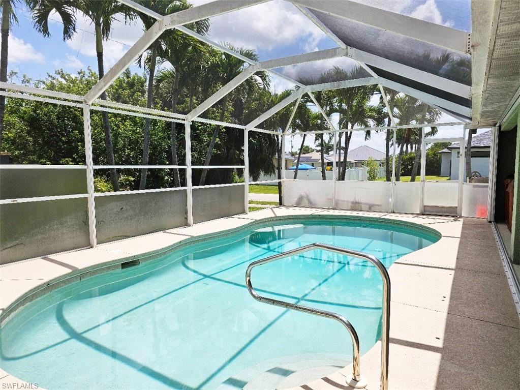 Swimming pool with a patio area, a sunroom, and a lanai