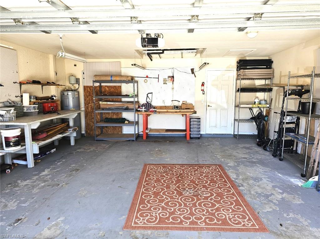 Garage featuring a workshop area and a garage door opener