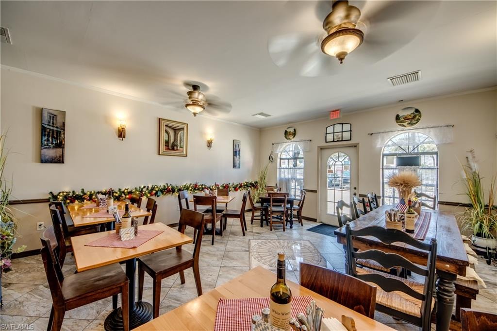 Dining room featuring ceiling fan and crown molding