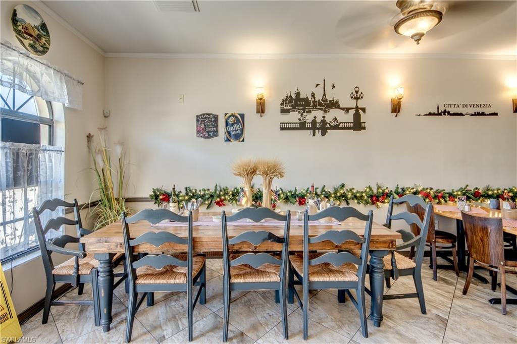 Dining area featuring crown molding and baseboards