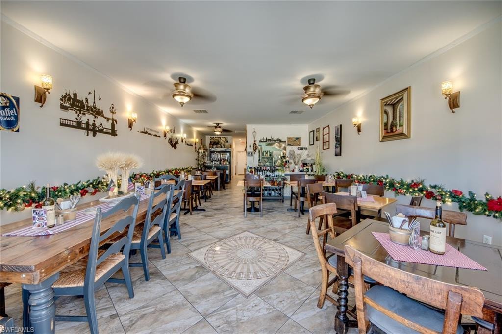 Dining room featuring ornamental molding and ceiling fan