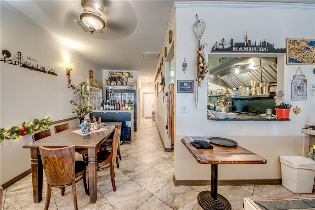 Dining area featuring ornamental molding and a ceiling fan