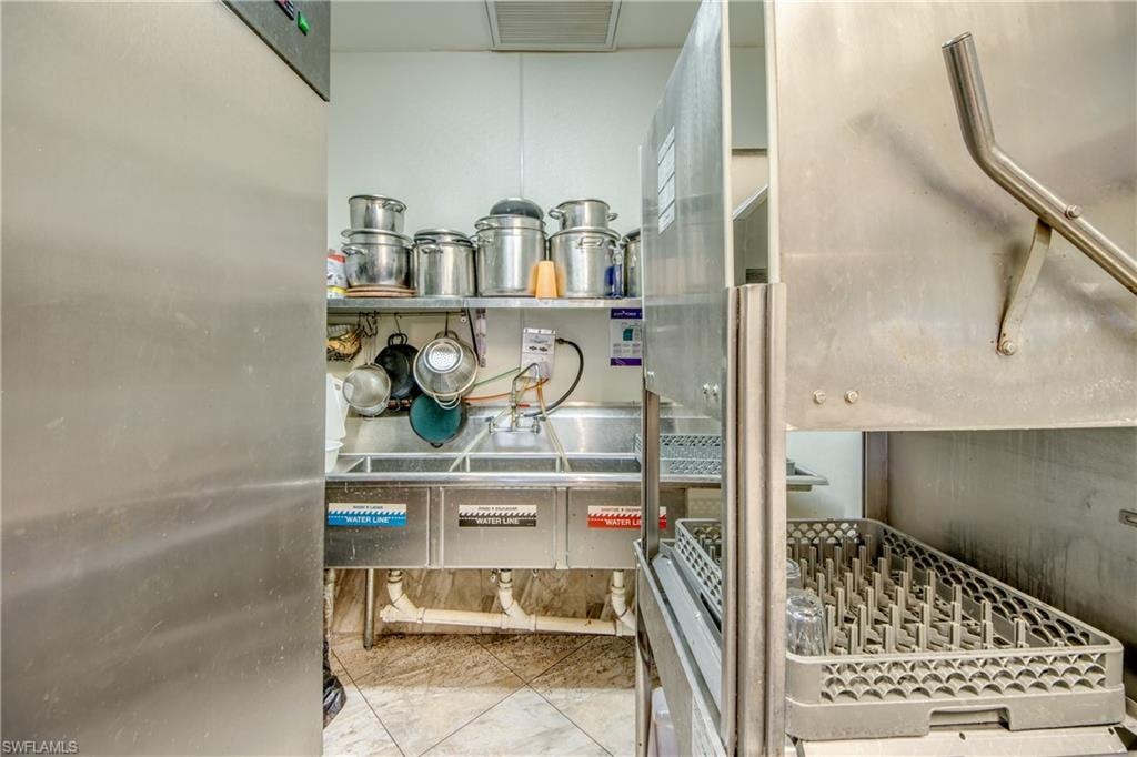 Kitchen view of stainless steel refrigerator