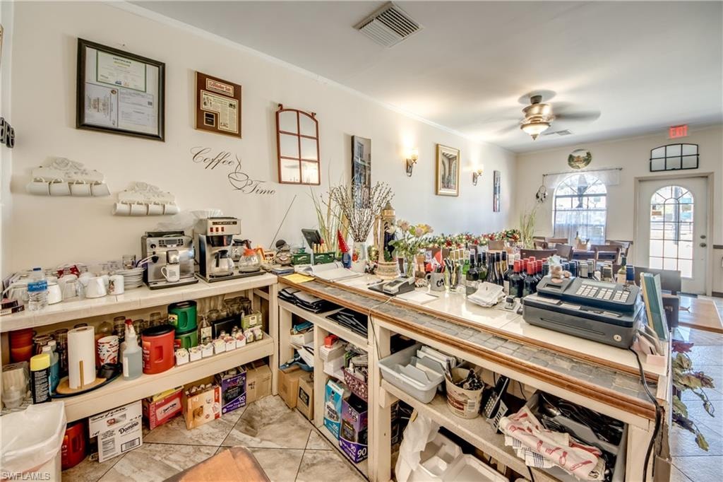 Miscellaneous room with ceiling fan and crown molding