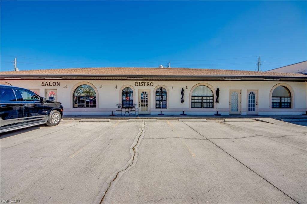 View of property with uncovered parking
