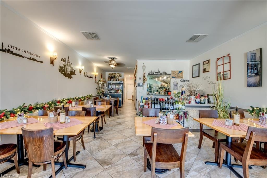 Dining area with ornamental molding and ceiling fan