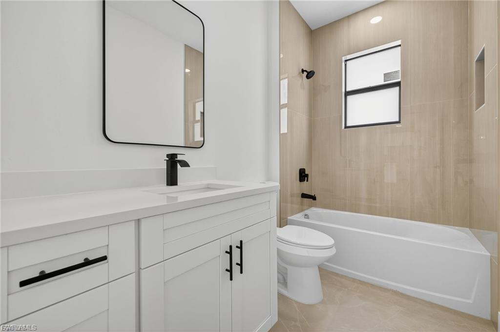 Full bath with vanity and shower / tub combination