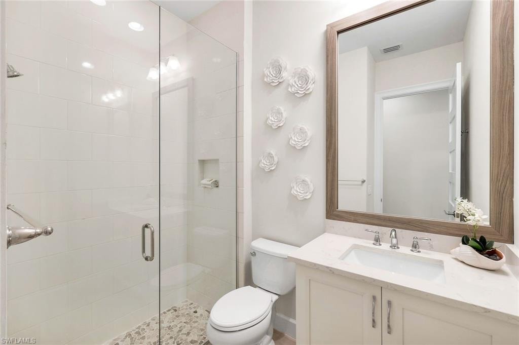 Full bathroom with vanity and a stall shower