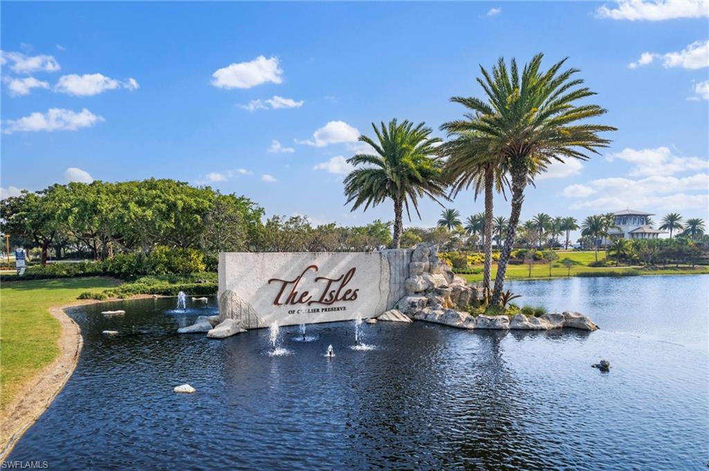 Community / neighborhood sign featuring a water view