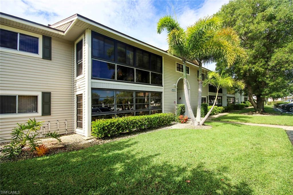 Rear view of property with a lawn