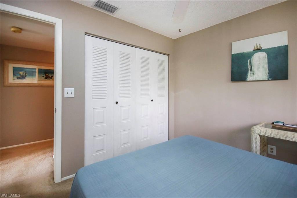 Bedroom with a closet, ceiling fan, and carpet floors
