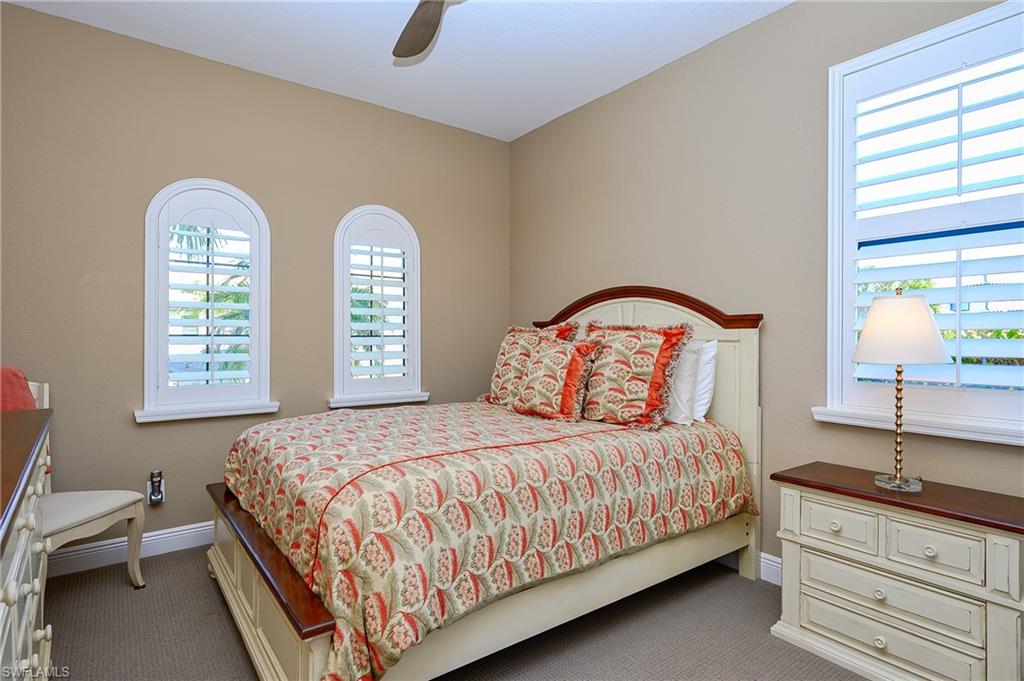 Carpeted bedroom and a ceiling fan