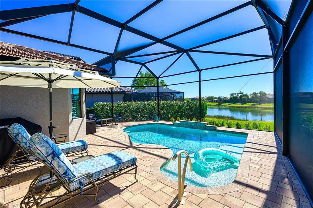 Outdoor pool featuring a water view, a patio area, and a lanai.