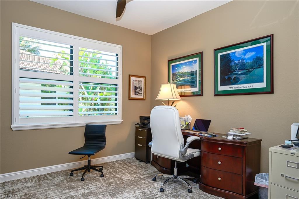 Home office featuring a ceiling fan and light colored carpet