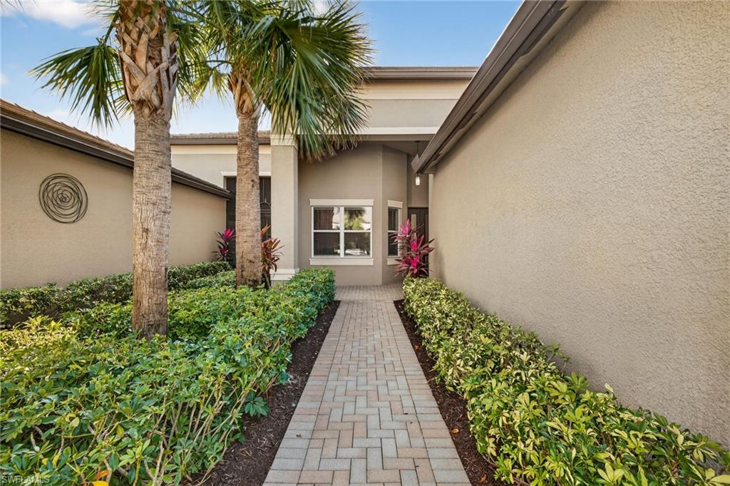 Doorway to property featuring stucco siding