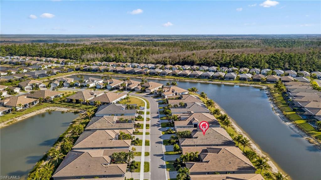 Aerial perspective of suburban area featuring a nearby body of water