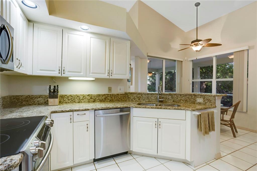 Kitchen features granite countertops and stainless steel appliances