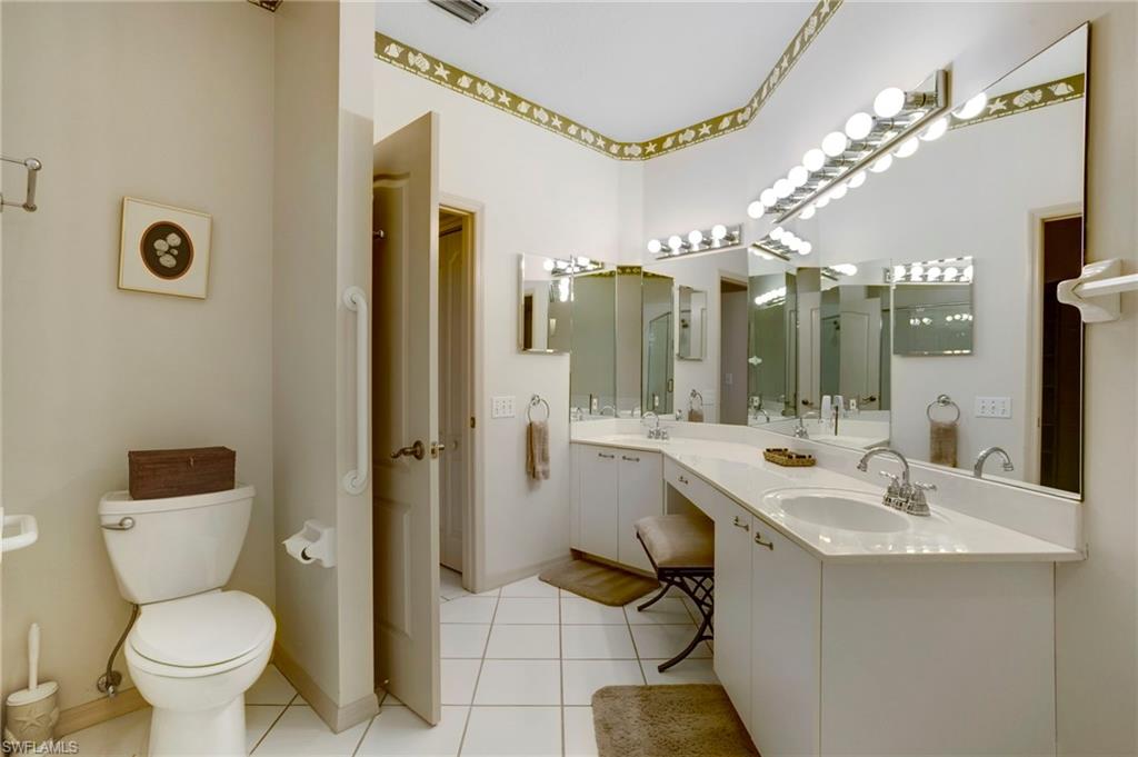 Primary bathroom has long vanity with double sinks