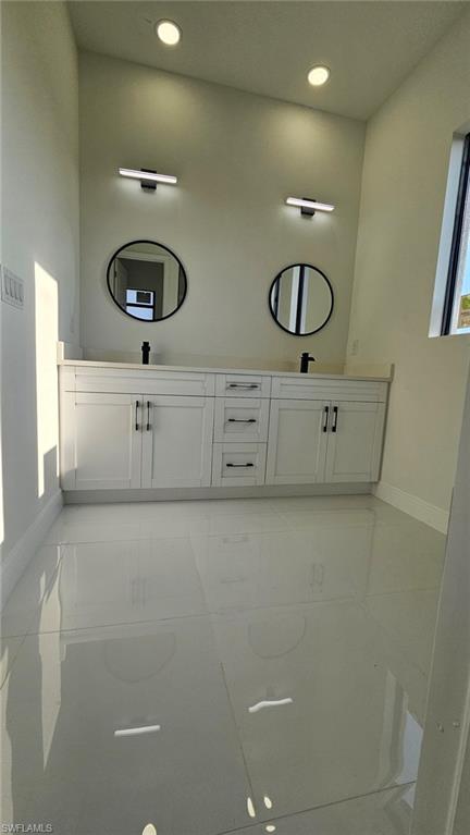 Full bathroom featuring double vanity and recessed lighting