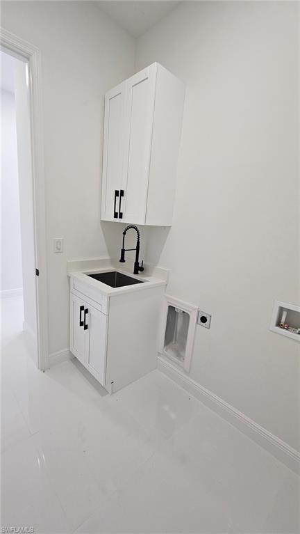 Laundry area featuring cabinet space, hookup for a washing machine, and hookup for an electric dryer