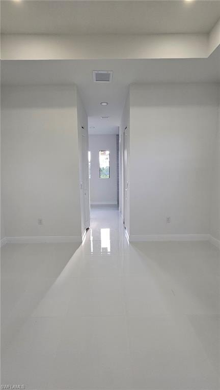 Hall featuring recessed lighting and light tile patterned floors