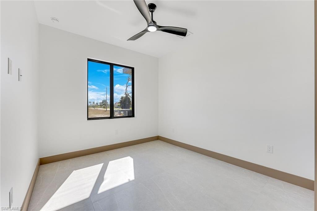 Bedroom 2 looking out at the pool has tray ceilings and walk in closet