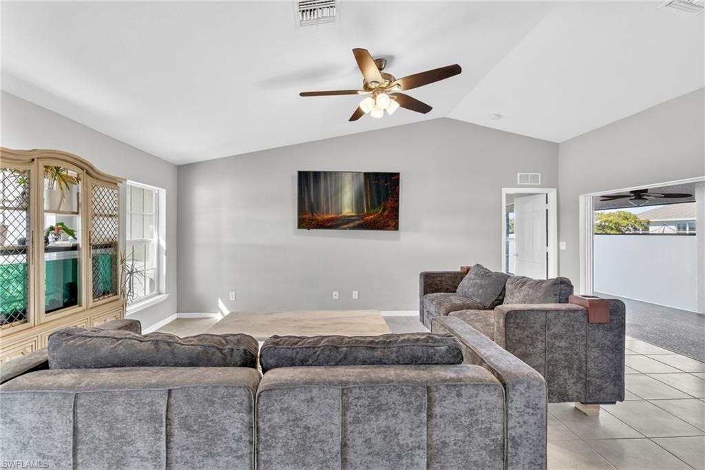 Living room featuring ceiling fan and light tile patterned floors