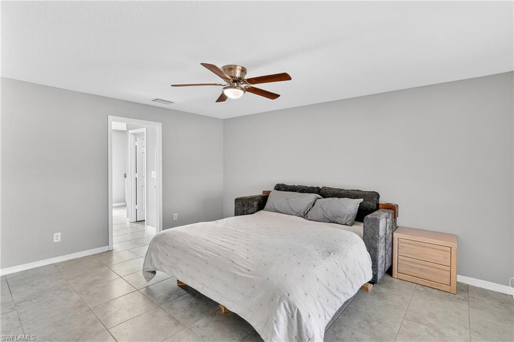 Bedroom featuring ceiling fan and light tile patterned flooring