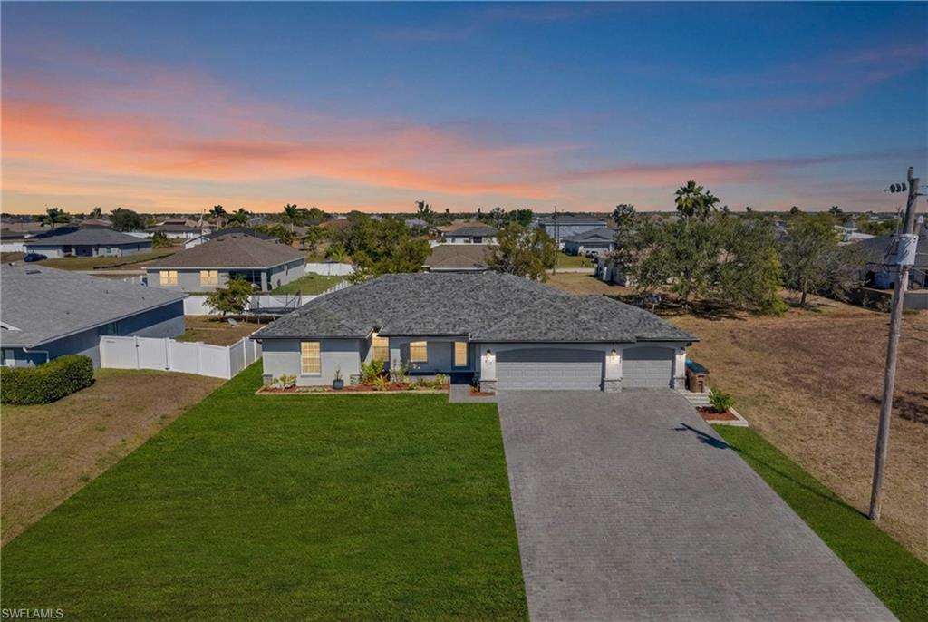 Ranch-style house with a garage, driveway, and a residential view