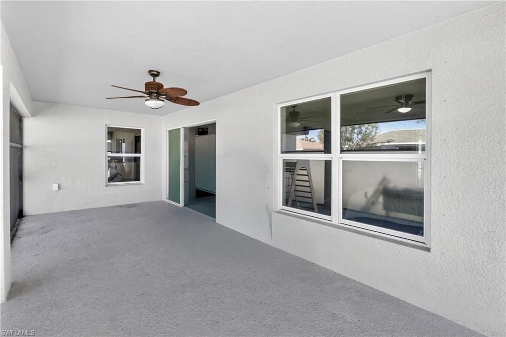 View of patio / terrace with a ceiling fan and a sunroom