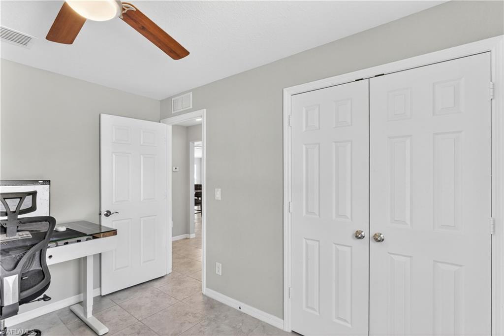 Office featuring a ceiling fan and light tile patterned flooring