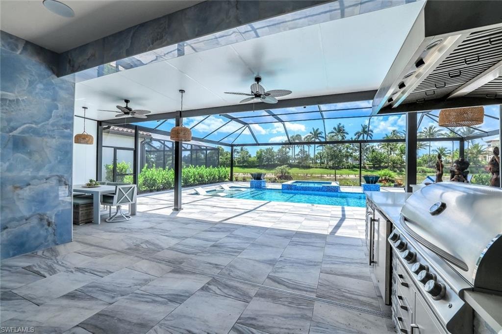 View of swimming pool featuring a ceiling fan, a pool with connected hot tub, and a patio area