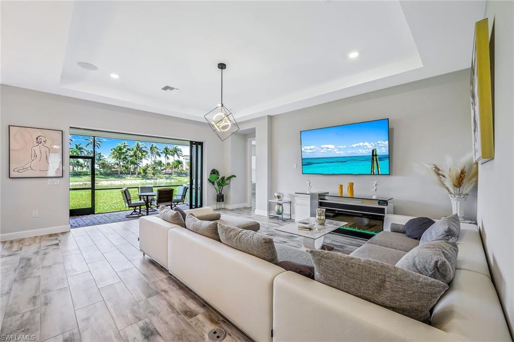 Living room featuring a tray ceiling and recessed lighting