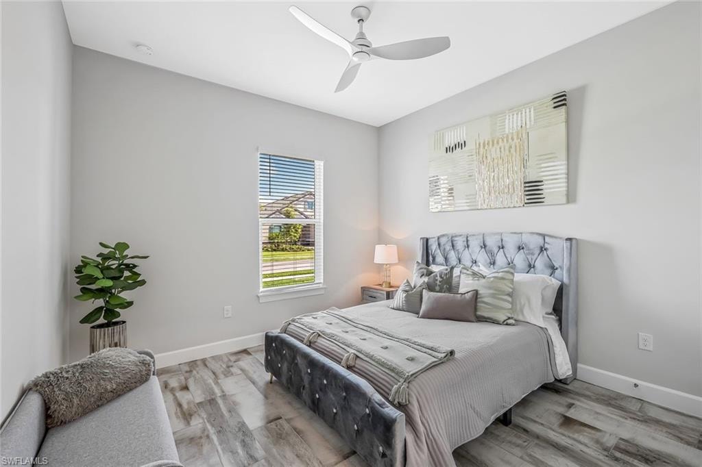 Bedroom with wood finished floors and a ceiling fan