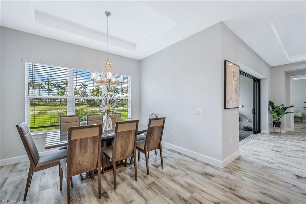 Dining room with a chandelier and light wood-style floors