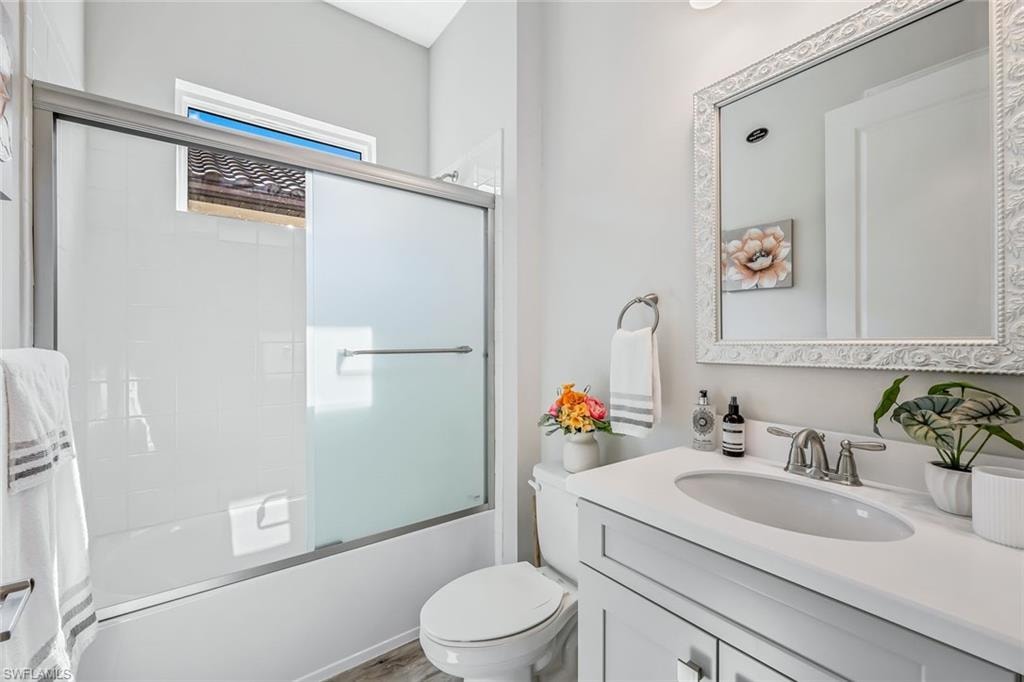 Bathroom with vanity and shower / bath combination with glass door