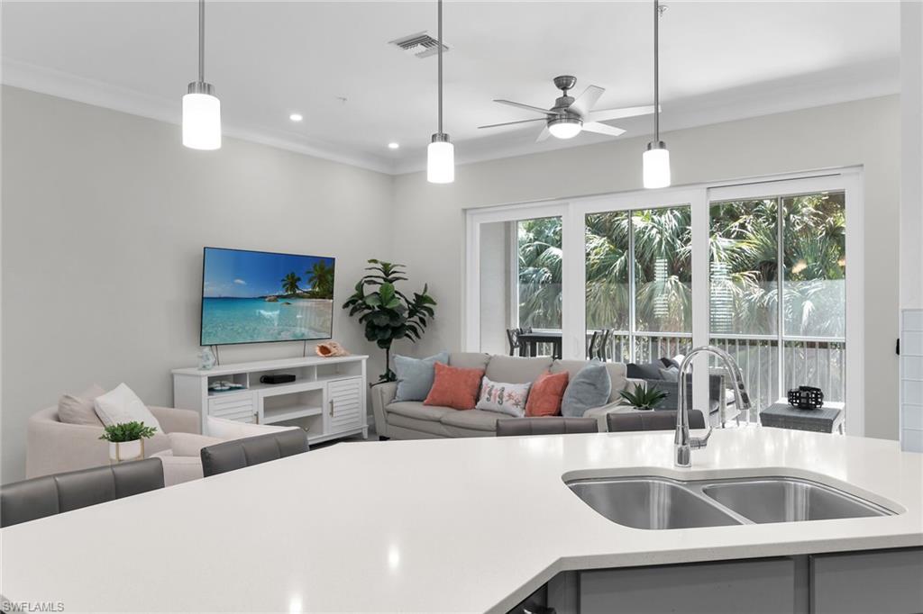 KITCHEN OPENS TO LIVING ROOM AND BALCONY VIEW