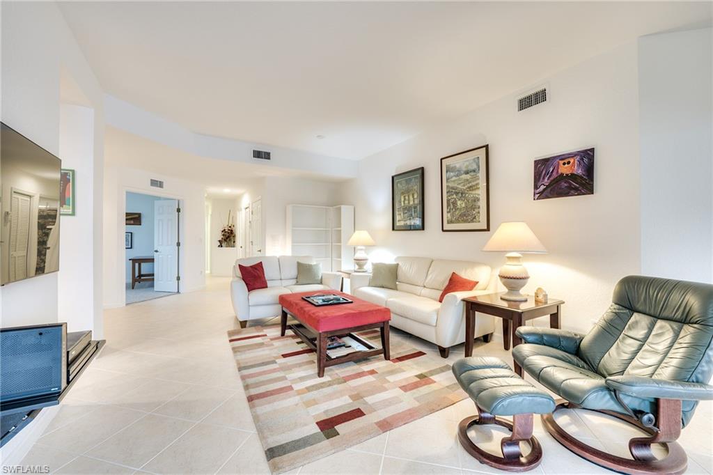 Den with French doors at left, guest bedroom and bath down the center hall at rear.  Laundry and garage at the end of the hallway