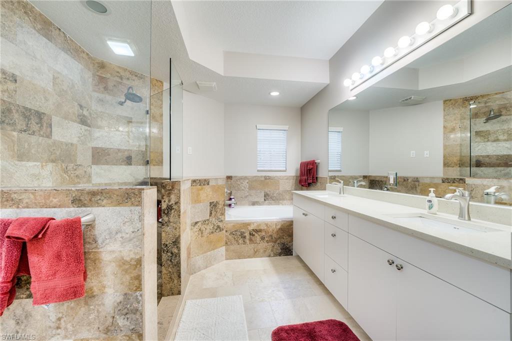 Fully update master bath, with new tile, frameless shower and countertops with dual sinks