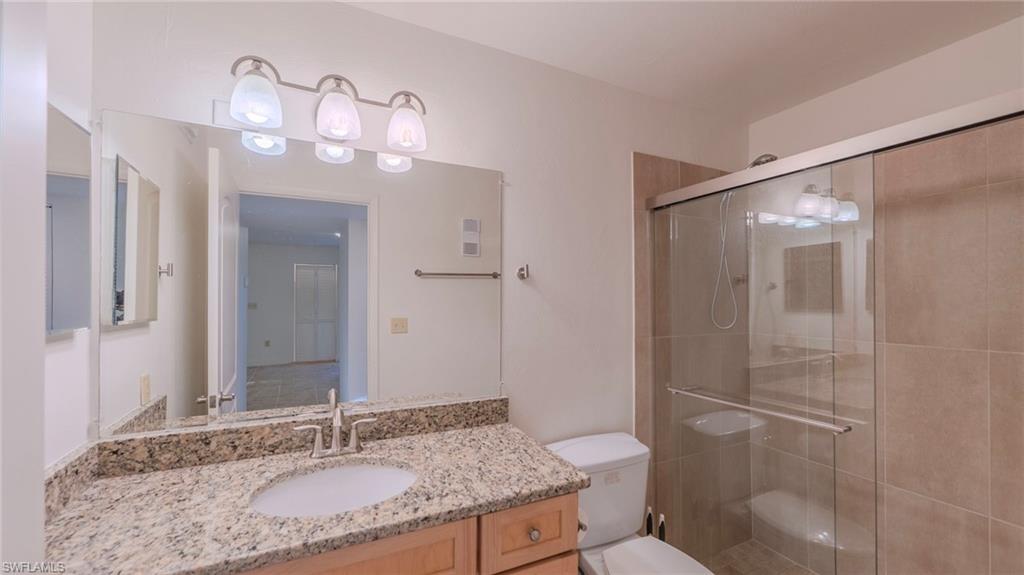 Full bath with vanity and a shower stall