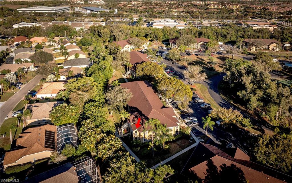 Aerial view of property and surrounding area with nearby suburban area