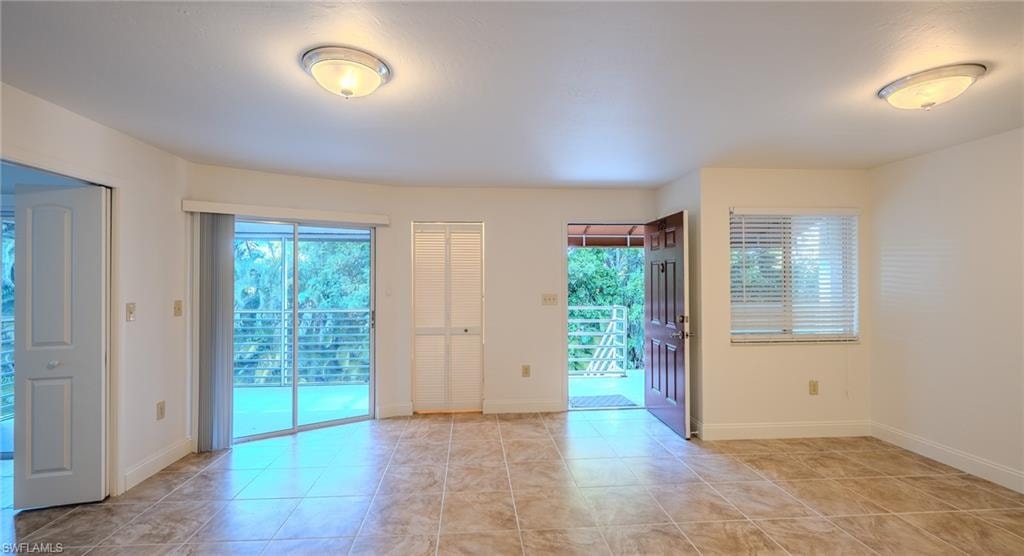 Unfurnished room with baseboards and light tile patterned floors
