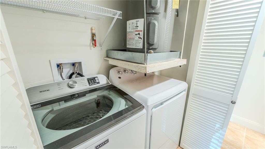 Laundry area with separate washer and dryer and baseboards